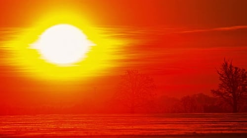 Time lapse of sunrise over a snow covered plain landscape. Amazing orange and golden light of nature
