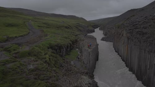 Rugged Terrain and Rushing River in Iceland