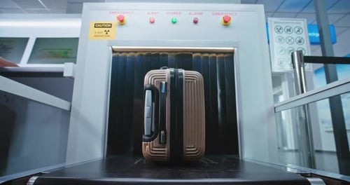 Security Check in Airport Passenger Places Suitcase on Conveyor Belt for Baggage Screening