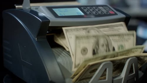 Automatic Cash Counting Machine Calculating 100 Dollar Banknotes. Currency Counting Machine. Credit