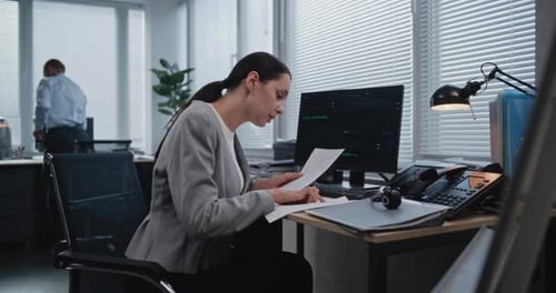 Professional Woman Working at Computer in Bright Office