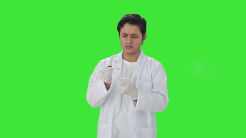 Confused Indian scientist doing scientific experiments Green screen