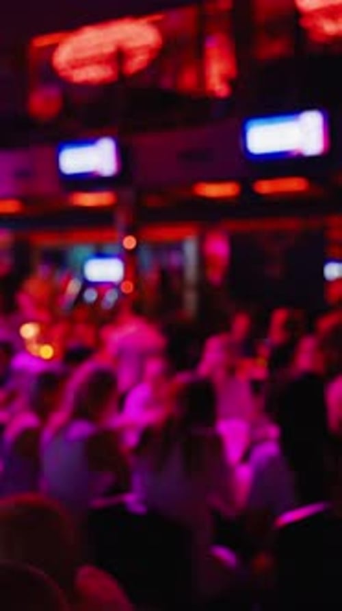 Captivating Footage Shows a Crowded Venue with a Blurred Background and Enchanting Purple Lighting