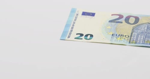 Putting on the white table banknotes of 20 euros. White background