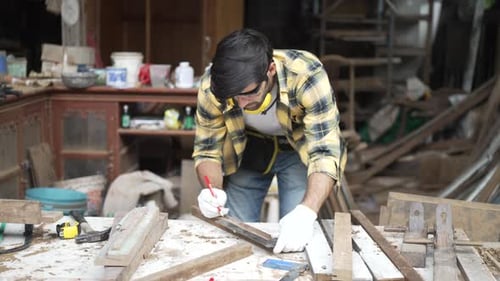 Carpenter make furniture at workshop.