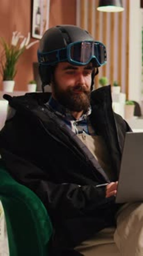 Vertical Video Young Adult Checks Website on Laptop