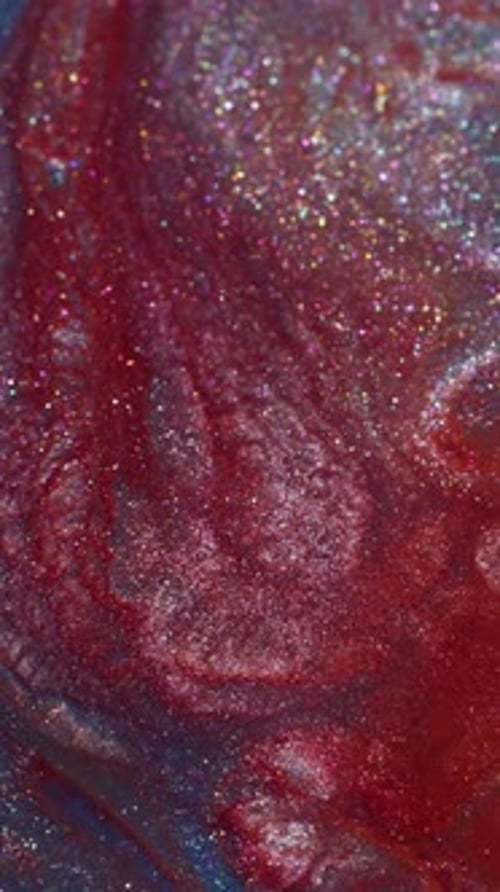 Abstract Liquid Paint Swirls of Red and Blue Glitter