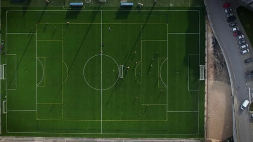 Drone view of a soccer pitch with players practicing