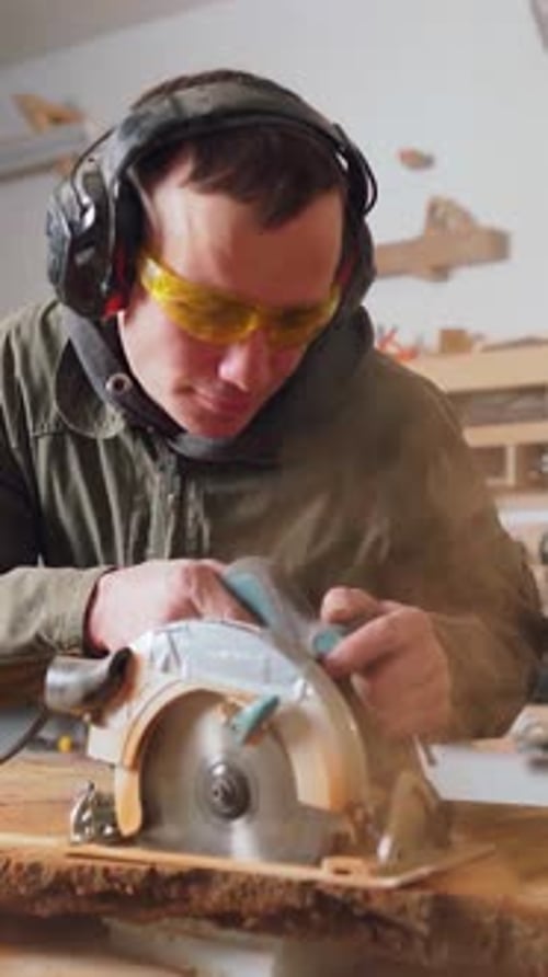 Man Cutting Wood with a Power Saw