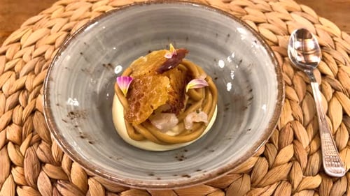 Close-up of fine dining dish prepared by a chef. А dessert of lychee and lavender, caramelized white