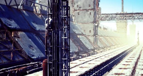 Industrial Setting with Machinery and Structures Under Bright Sunlight