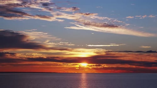 Timelapse avec coucher de soleil et cumulus volant haut dans un beau ciel bleu, soleil, aube dans la mer