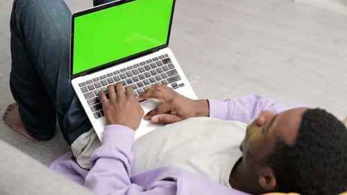 Black Man Using Laptop Notebook Viewing Green Screen Press Keyboard Browsing Chroma Key African