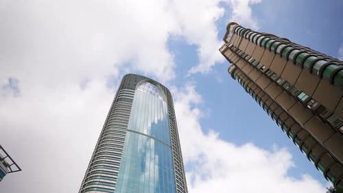 Bottom Up View of Skyscrapers Against Blue Cloudy Sky