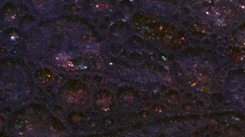 Fluid with Glitter Bubbles Resembling Outer Space Galaxy