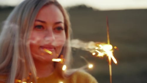 Happy Cute Girl Holding a Sparkler