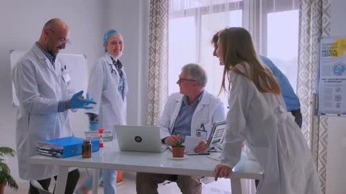 Doctors Collaborating on Medical Documents During Office Meeting