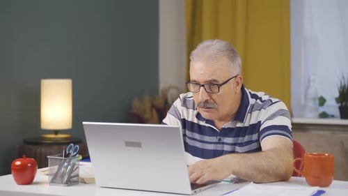 Home office worker old man see his failure on laptop.