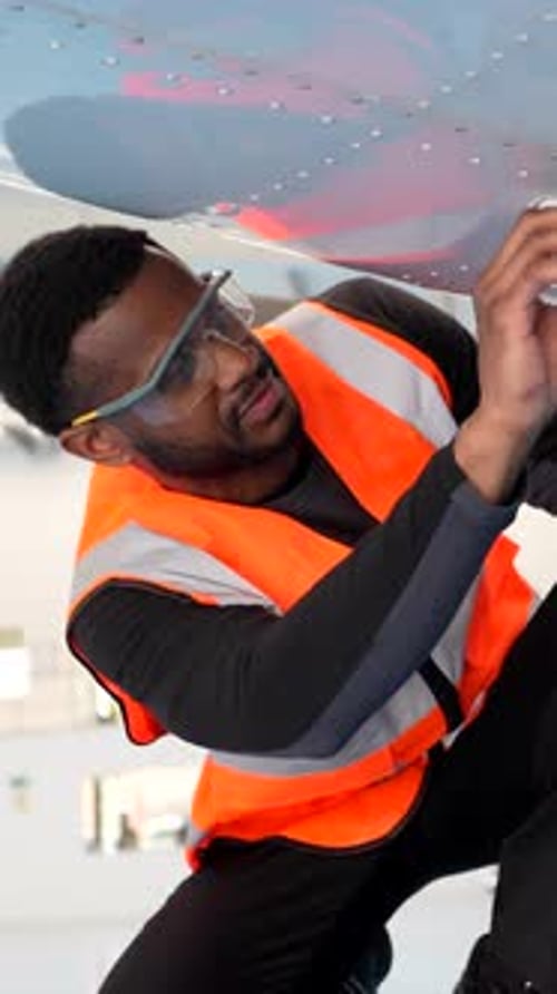 Aircraft Maintenance Engineer Installing Pitot Tube on Airplane Wing