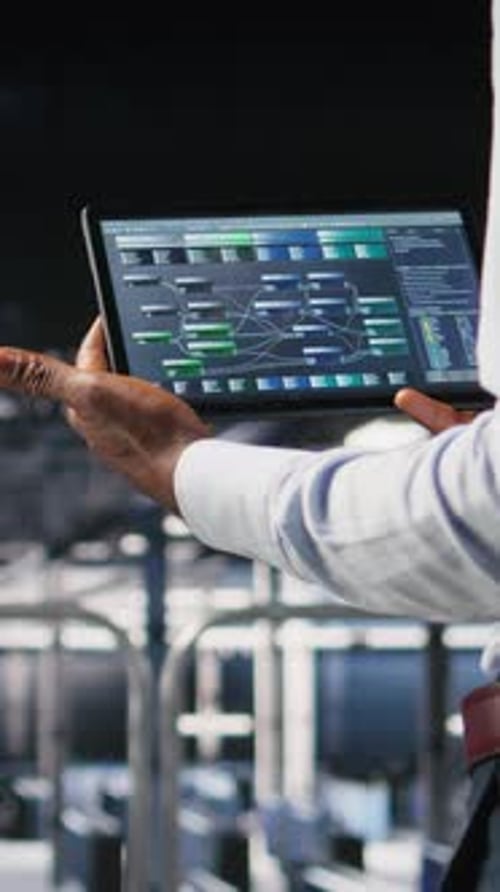 Vertical Video Data Center Admin Checking Code on Tablet Next to Colleague