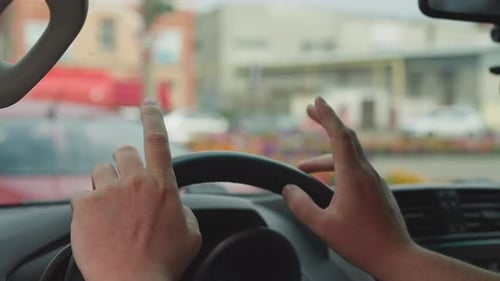 Close Up Of Hands Holding Steering Wheel
