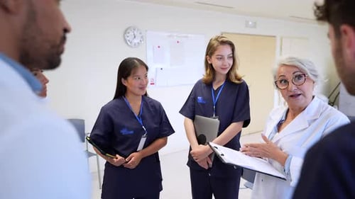 Medical Team Meeting Discussing Patient Charts in Hospital