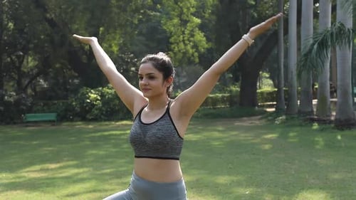 Video clip of Indian woman practicing yoga in tree pose.