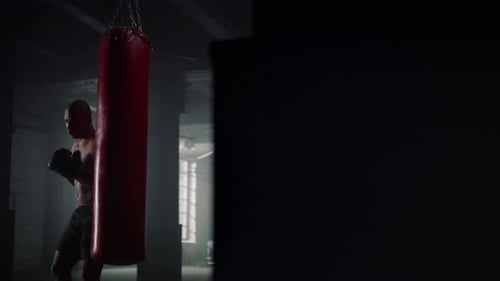 Professional Boxer Boxing Training Punch Bag in Fighting Club. Powerful African American
