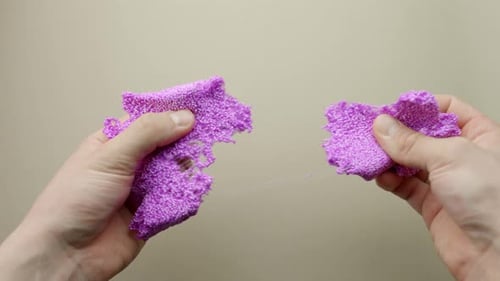 Relax therapy - purple slime with glitter in person hands, POV
