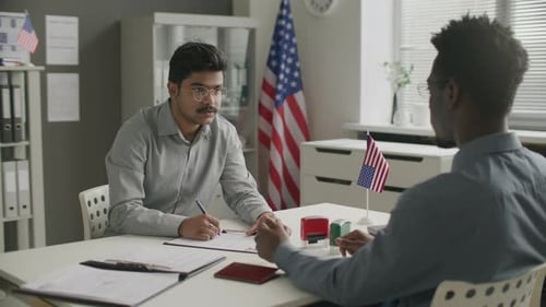 Indian Visa Applicant Filling Out Documents in American Embassy