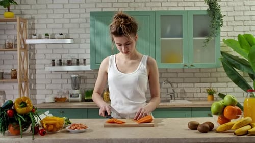 Young Woman at the Table in the Kitchen Preparing Spring Rolls for Healthy Lunch Woman Cutting