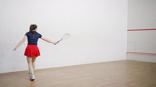 Fit Squash Lady Player Hits Small Ball Against Front Wall