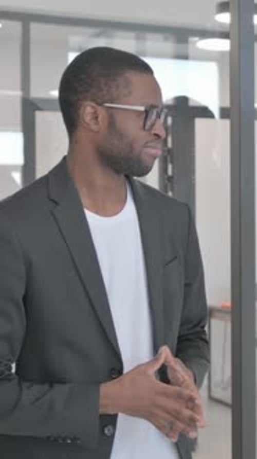 Young Adult Man in Suit Talking in Office