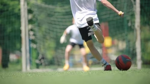 Close-up of a Football Player Taking a Kick to Score
