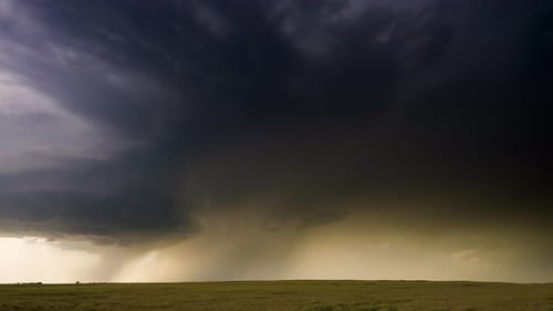 Dramatic Storm Rolling Across Golden Rural Landscape