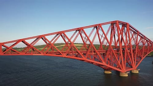 Aerial Angle of Train Travelling Along The Fourth Railway Bridge in South Queensferry on a Sunny Sum