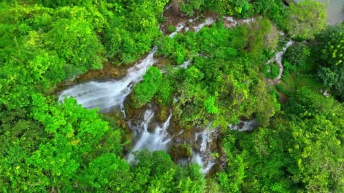 Beautiful waterfall in a tropical forest by aerial view from a drone.