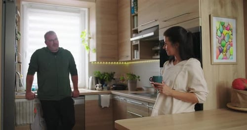 Man and Woman Talking in Modern Kitchen