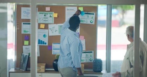 Team Members Reviewing Business Charts in Modern Office