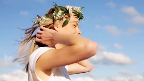 Happy Woman Wearing Floral Crown Outdoors in Sunlight