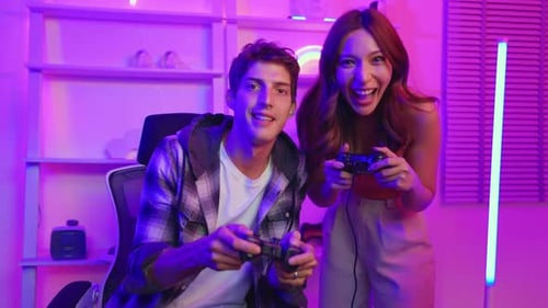 Young Couple Gaming Together at Home