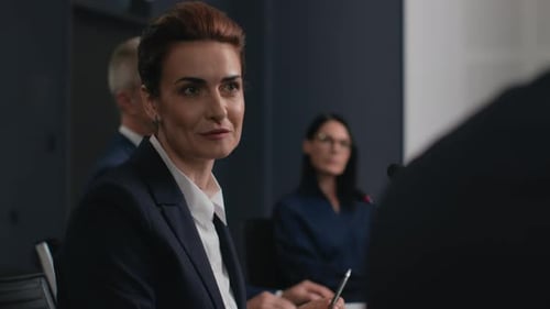 Businesswoman Speaking at Conference Meeting with Colleagues