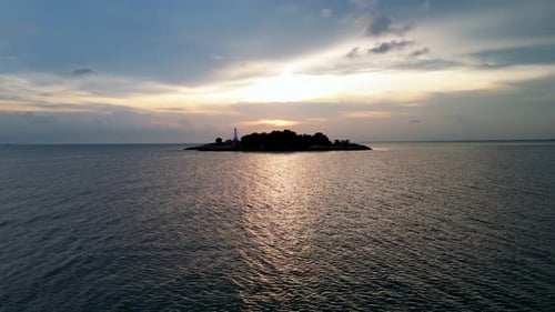 A small island is in the middle of the ocean.