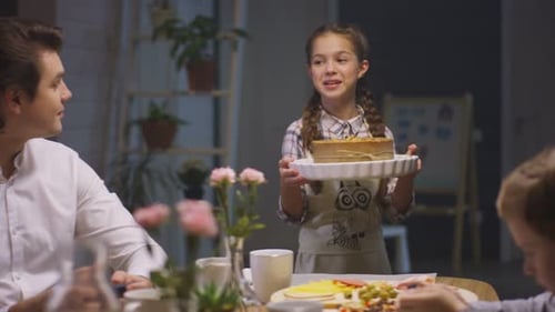 Family Celebrates Birthday with Cake at Home