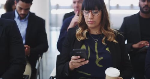 4k video footage of businesspeople sitting in a convention center during a conference