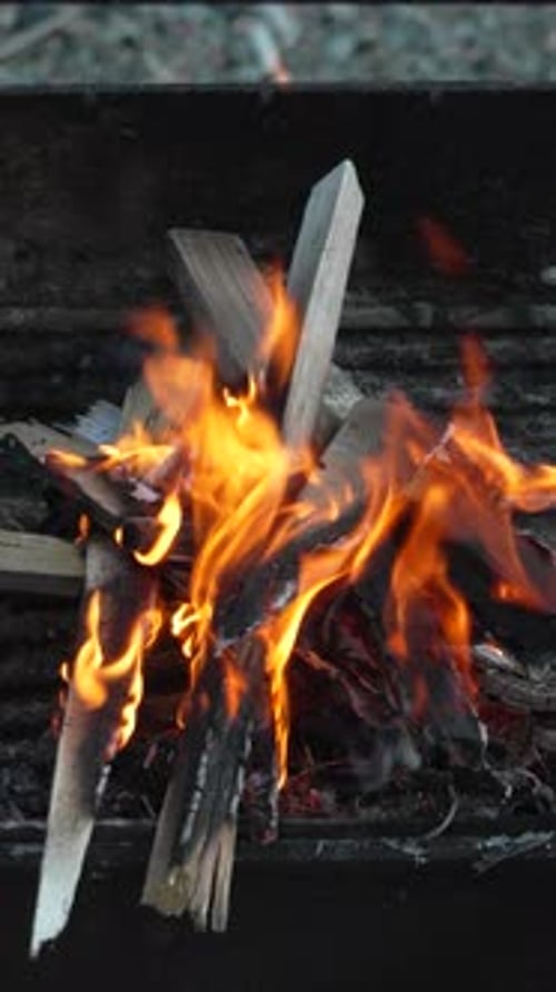 Fire Burning Wood Orange Flames in a Metal Barbecue Grill Warm and Hot Vertical Video