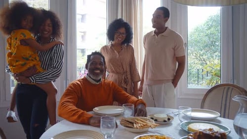 Family Gathering Around Dining Table in Bright Home