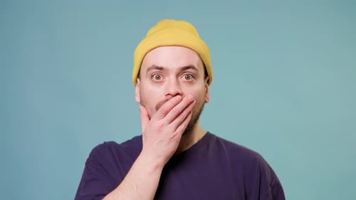 Man Reacts with Surprise Covering His Mouth