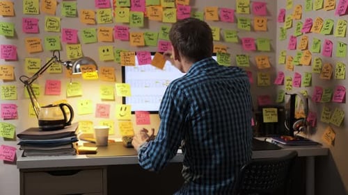 Busy Person Working at Desk with Sticky Notes