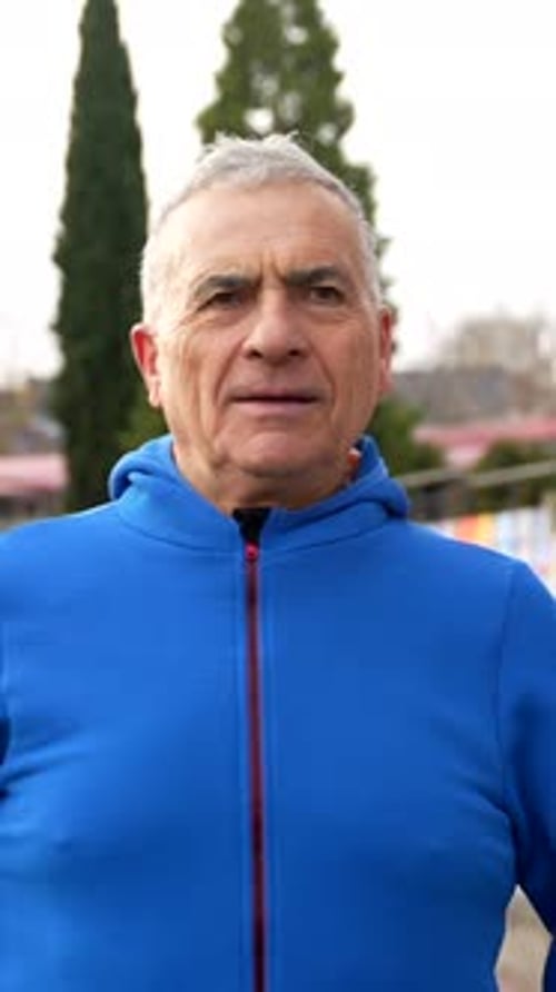 Senior Man Stretches Arms Outdoors